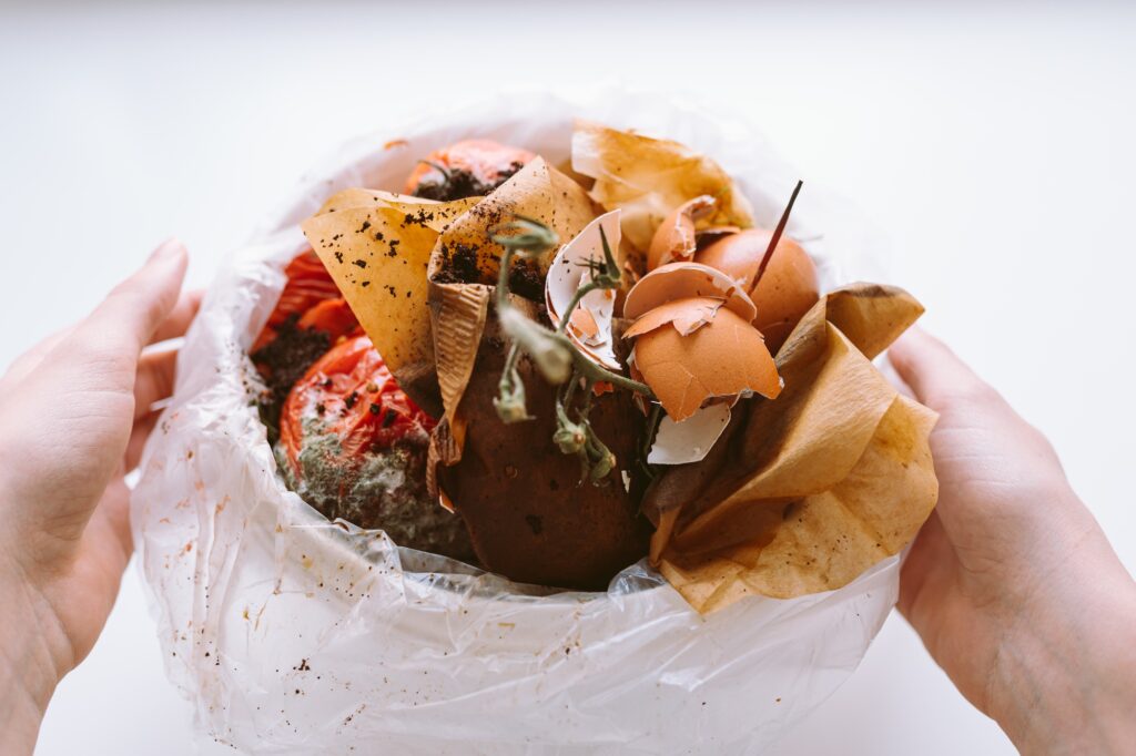 Bucket with biological garbage, food waste in biodegradable package