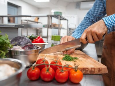 The chef in brown apron cooking in a restaurant kitchen